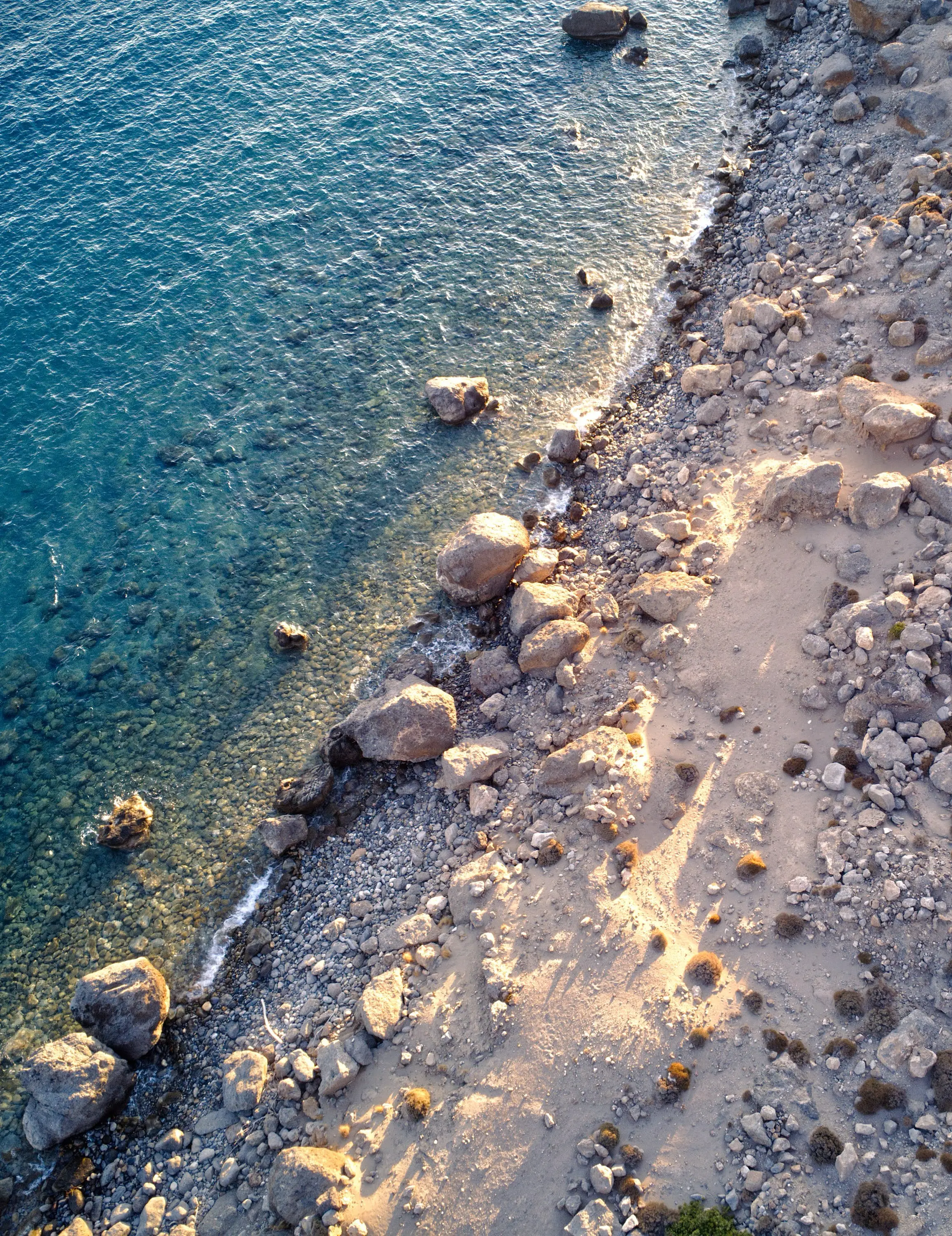 Rocky coastline with clear blue water in Crete