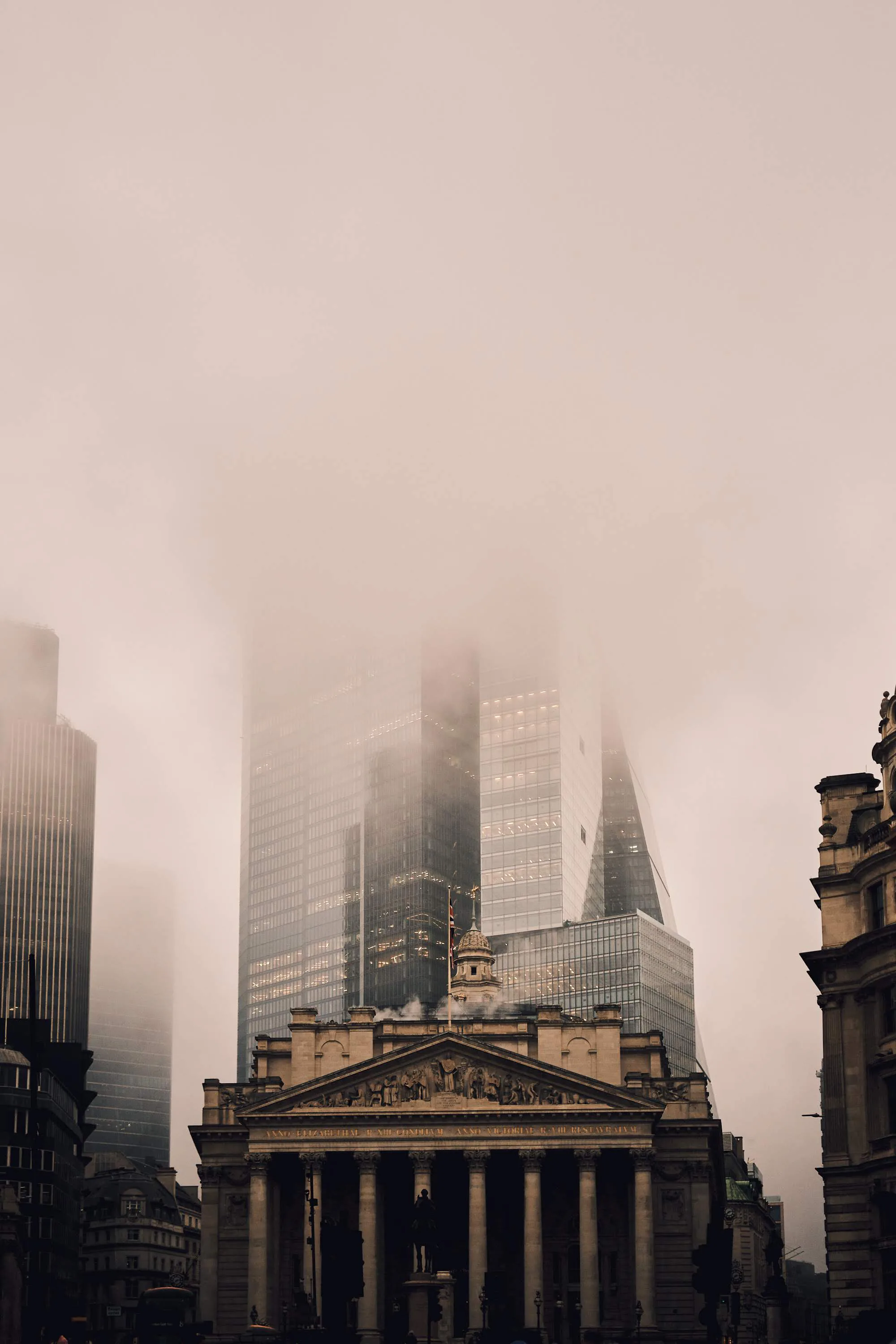 Foggy London skyline rising behind the Royal Exchange